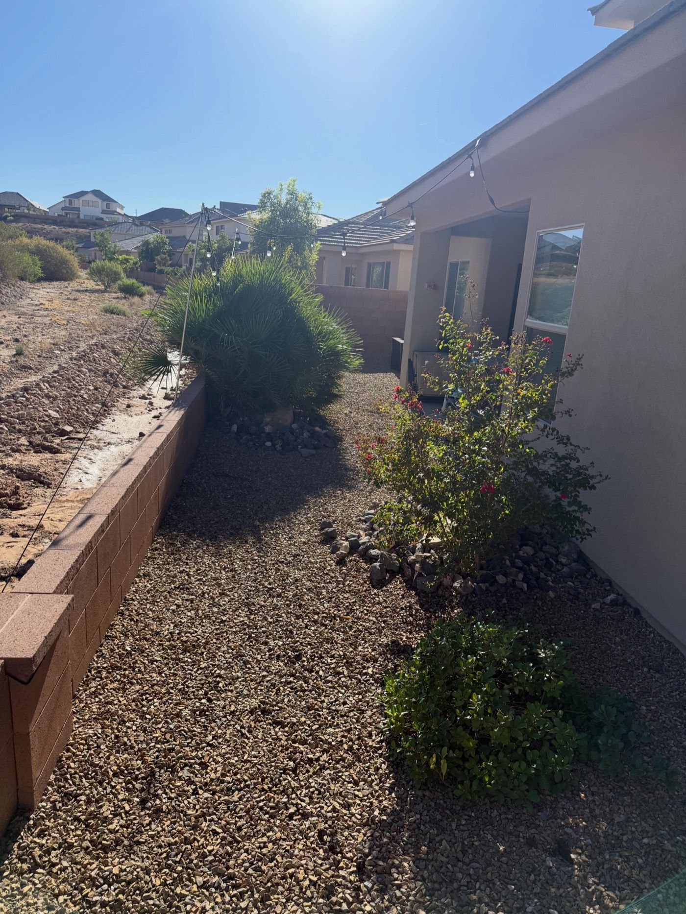 Rock mulch beds with shrubs along a house